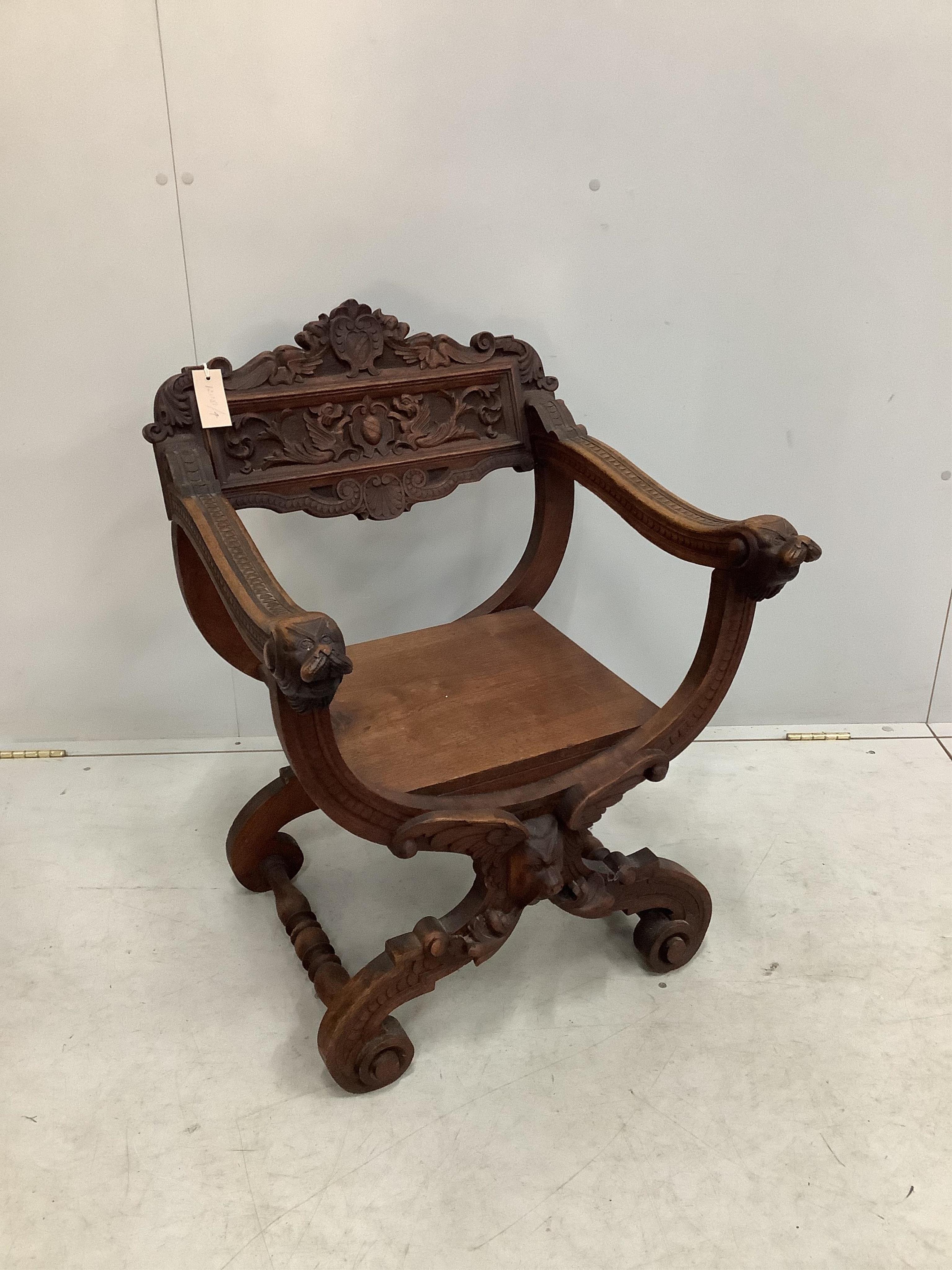 A carved 'X' framed chair, width 58cm, depth 53cm, height 79cm. Condition - fair